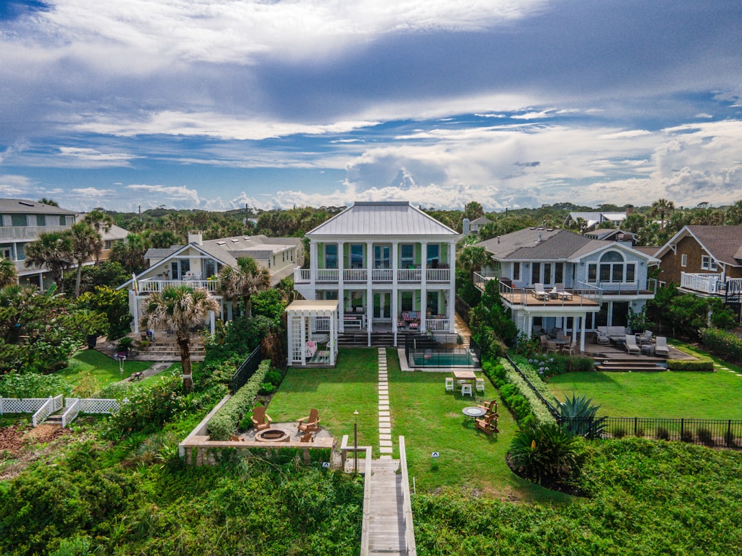 Naples waterfront estate with dock and coordinated hardscape from pool deck to water