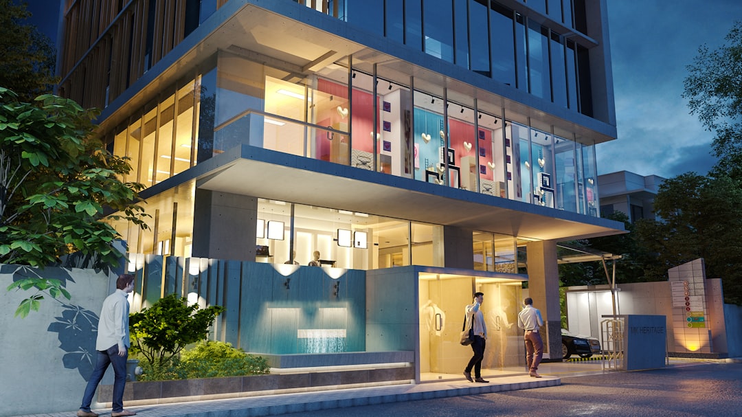 Outdoor estate at night with warm amber lighting on tropical planting and pool