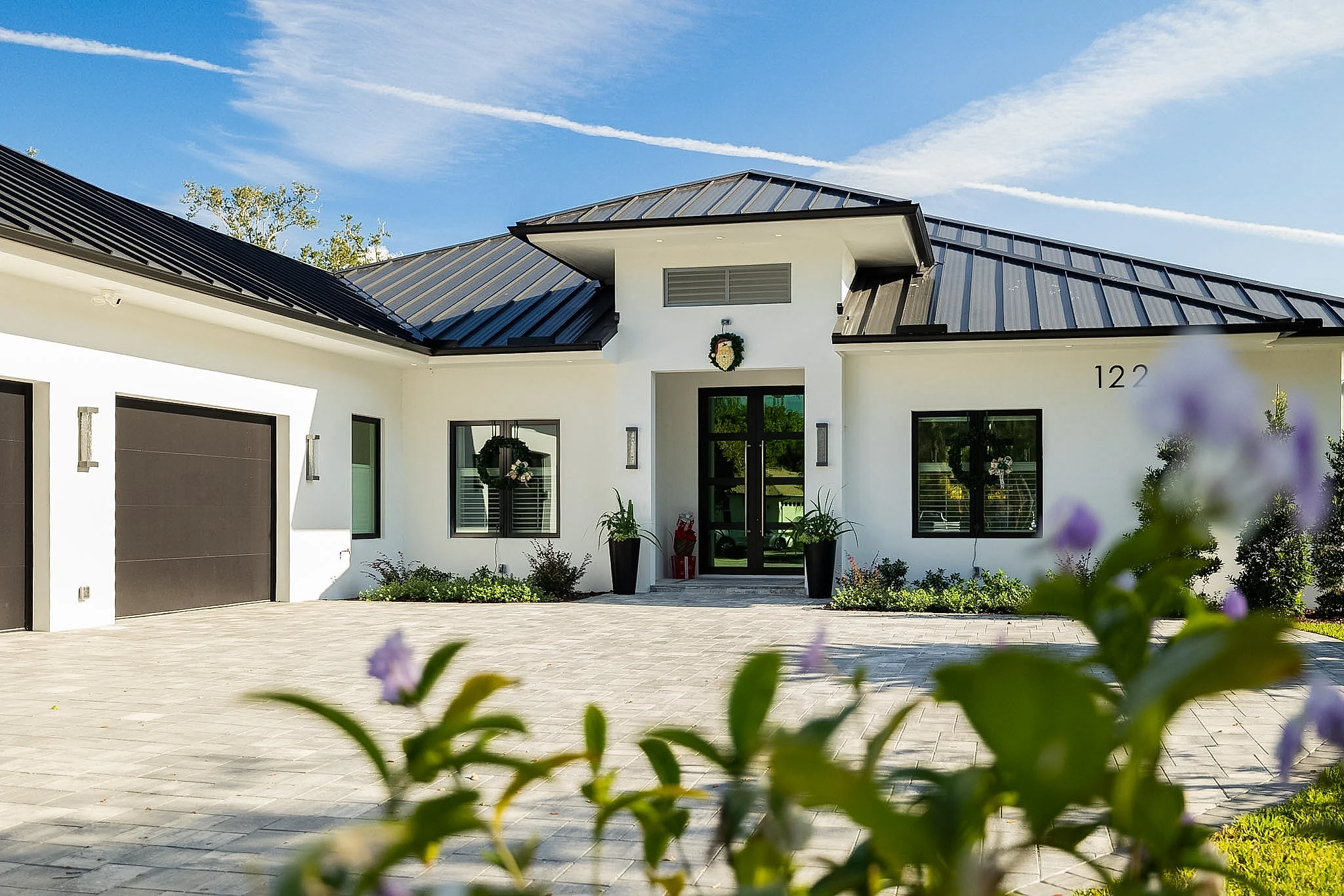 Modern estate exterior with paver motor court — 122 Westwood Drive, Naples