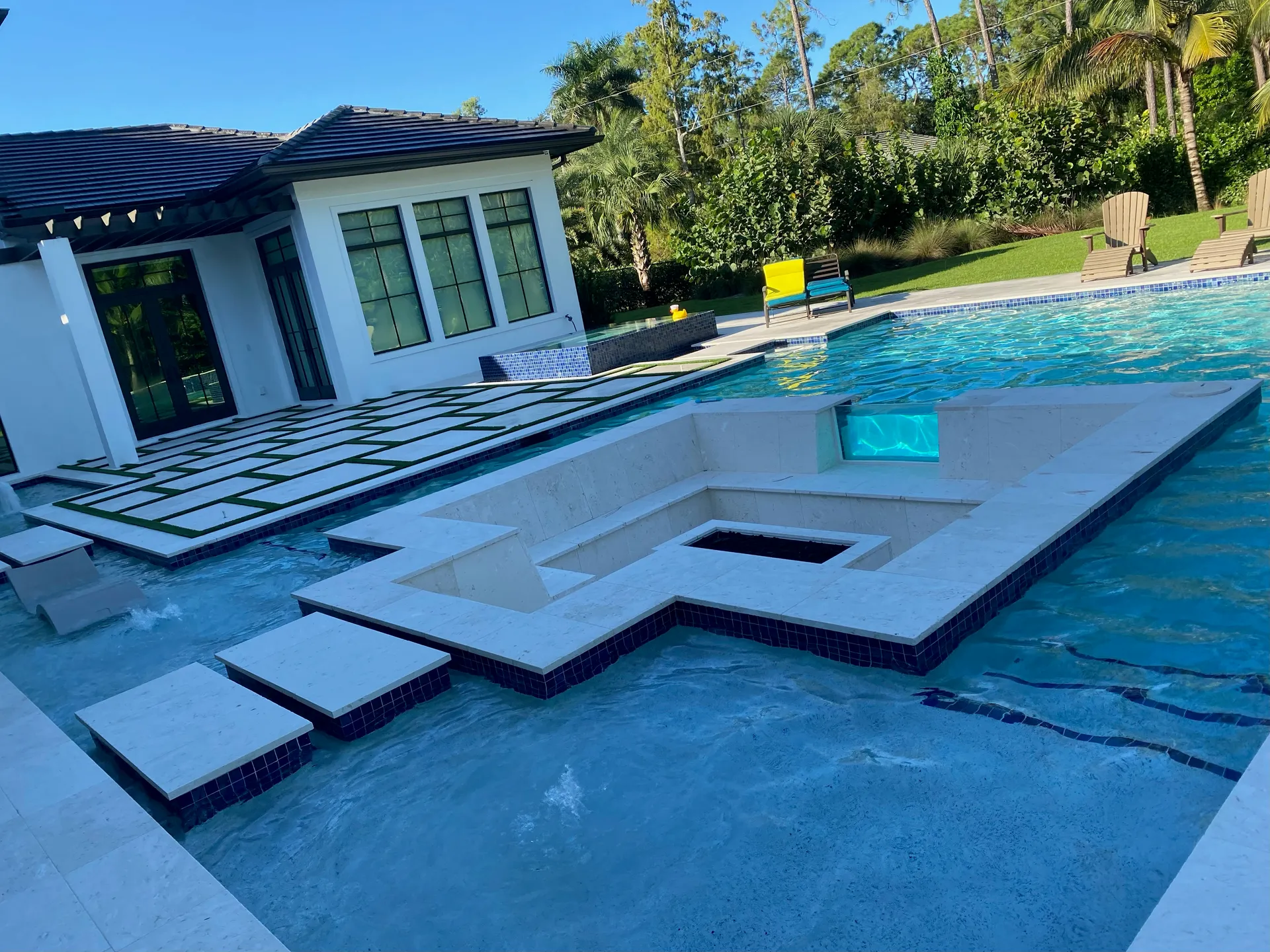 Travertine sun shelf, stepping stones, and pool deck, Naples FL