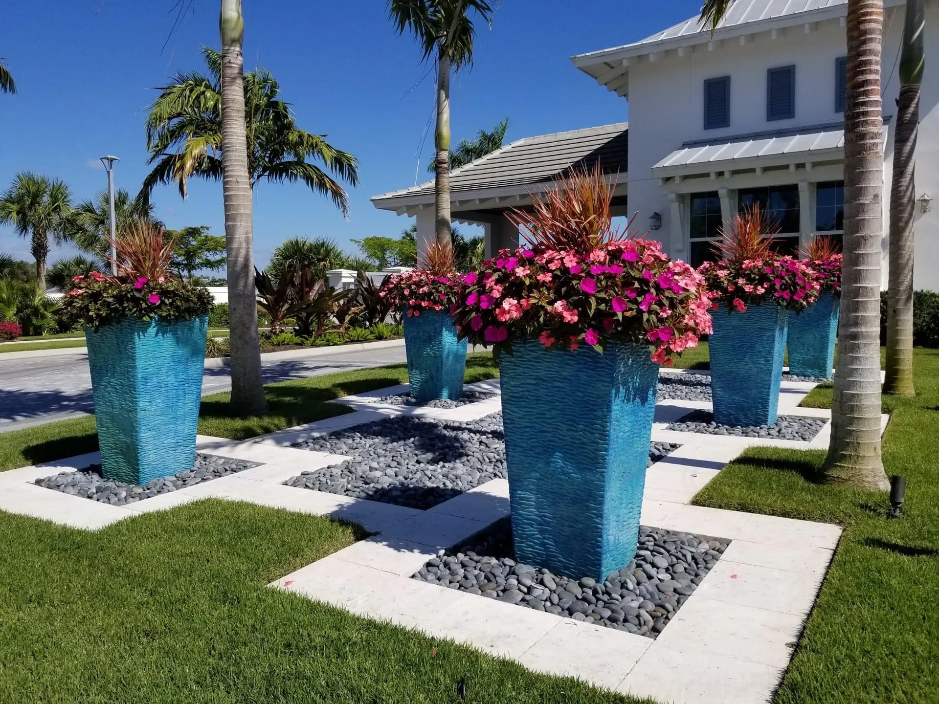 Custom planters with tropical color planting — Southwest Florida estate