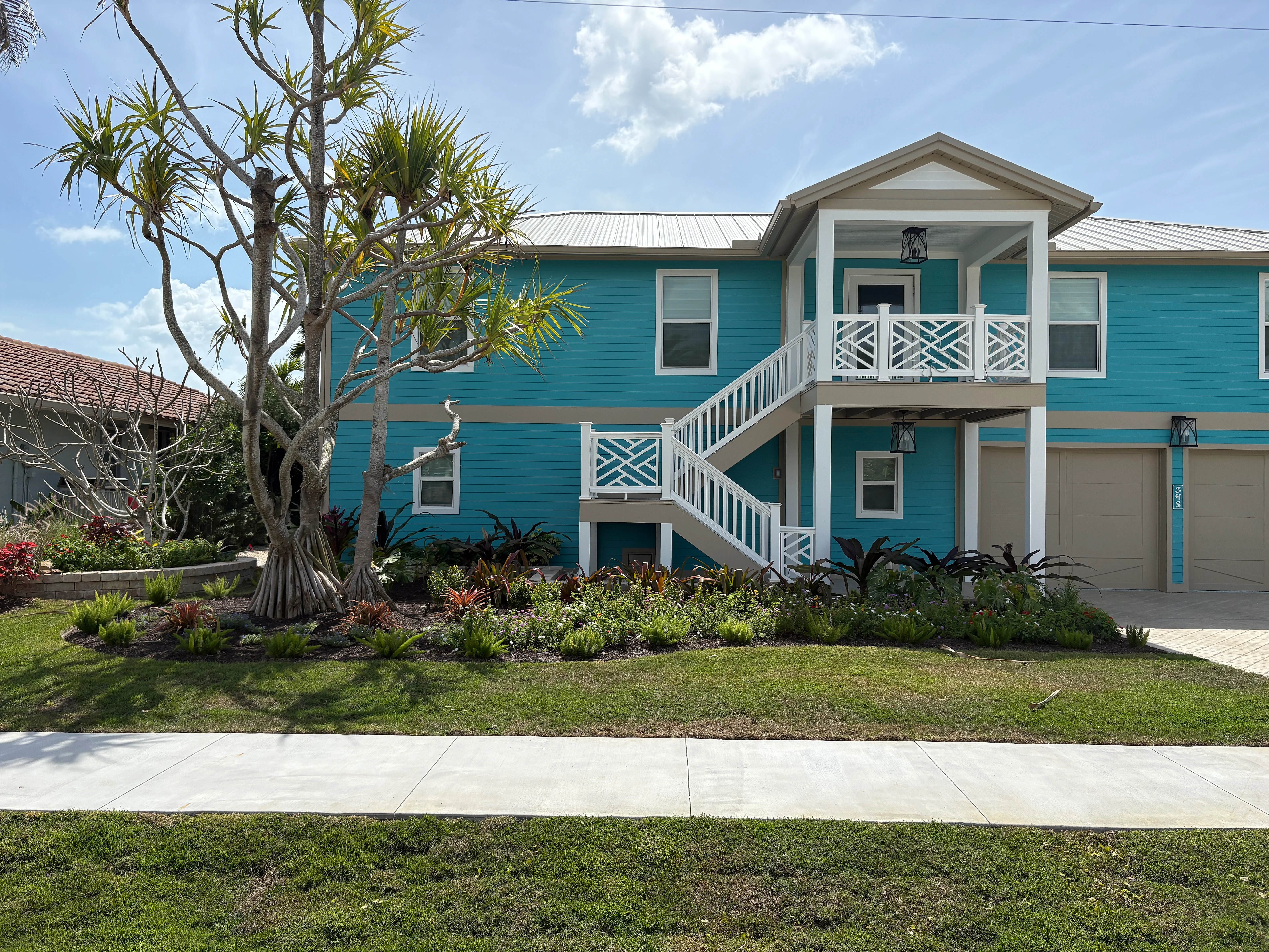 Coastal estate with tropical planting design and paver driveway — Southwest Florida