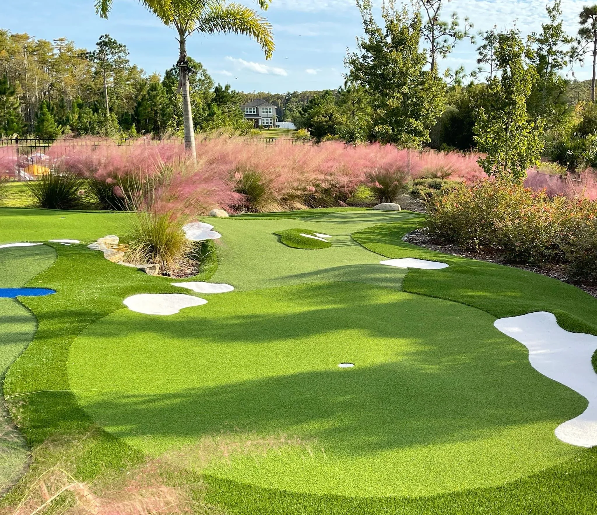 Private estate putting green with pink muhly grass — Southwest Florida