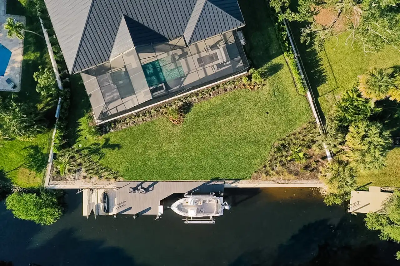 Aerial view of completed Naples estate with pool, dock, and landscaping by Precision Landscaping and Design